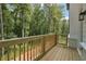 View of wood deck overlooking wooded lot and featuring wood railings and siding on home at 3930 Clifton Hill Court #15, Cumming, GA 30040