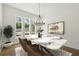 Bright dining room with white marble table and modern chandelier at 3930 Clifton Hill Court #15, Cumming, GA 30040