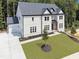 Stunning two-story painted brick home with a dark roof, lush lawn, and an attached two car garage at 3930 Clifton Hill Court #15, Cumming, GA 30040