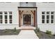 Beautiful entryway to brick home, featuring wood columns and glass doors at 3930 Clifton Hill Court #15, Cumming, GA 30040
