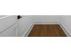 Charming hallway featuring beautiful hardwood flooring and stylish white trim at 3930 Clifton Hill Court #15, Cumming, GA 30040
