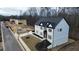 Shot of a two-story new construction home with black roof and freshly sodded yard at 3930 Clifton Hill Court #15, Cumming, GA 30040