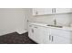 Convenient laundry room with modern cabinetry, stylish floor tiles, and a sleek countertop at 3930 Clifton Hill Court #15, Cumming, GA 30040