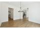 Open living room with hardwood floors and modern lighting at 3930 Clifton Hill Court #15, Cumming, GA 30040