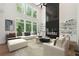 Bright living room with tall windows, fireplace with built-ins and comfortable seating at 3930 Clifton Hill Court #15, Cumming, GA 30040