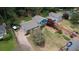 Beautiful aerial shot of a house with a large driveway and expansive yard with workers setting brick at 493 James Street Sw, Lilburn, GA 30047