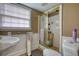 Cozy bathroom with a shower, toilet, vanity, and window allowing for natural light at 493 James Street Sw, Lilburn, GA 30047