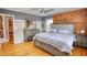 Bedroom with hardwood floors, natural light, bed, and ceiling fan at 493 James Street Sw, Lilburn, GA 30047