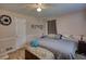 Bedroom featuring a cozy bed with a blue quilt and a decorative sombrero on the wall at 493 James Street Sw, Lilburn, GA 30047