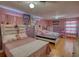 This bedroom features two twin beds, hardwood floors, and is decorated with posters and colorful accents at 493 James Street Sw, Lilburn, GA 30047