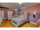 Bedroom with hardwood floors, two beds, and unique decor at 493 James Street Sw, Lilburn, GA 30047