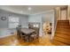This dining area features hardwood floors and a staircase leading up to the second level at 493 James Street Sw, Lilburn, GA 30047