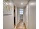 Hallway with tile floors leading to a bathroom and closet space at 493 James Street Sw, Lilburn, GA 30047