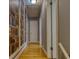 Hallway showcasing hardwood floors and a unique wallpaper design resembling bookshelves at 493 James Street Sw, Lilburn, GA 30047