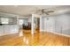 Bright living room features hardwood floors, large windows, neutral paint, ceiling fan and opens to the kitchen at 493 James Street Sw, Lilburn, GA 30047