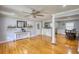 Bright living room features hardwood floors, large windows, neutral paint, ceiling fan and opens to the kitchen at 493 James Street Sw, Lilburn, GA 30047
