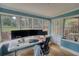 Bright sun room with large windows, ideal for a home office or relaxation area at 493 James Street Sw, Lilburn, GA 30047