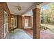 Brick back porch with ceiling fan, brick pillars, and a clear view of the backyard at 1418 Brighton Pl, Loganville, GA 30052