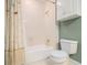 Cozy bathroom featuring a bathtub and shower, with neutral wall and white tiled wall at 1418 Brighton Pl, Loganville, GA 30052