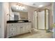Bathroom features a walk-in shower, granite countertop, neutral wall, and vanity with detailed pulls at 1418 Brighton Pl, Loganville, GA 30052