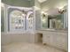 Luxury bathroom with tile floor, columns, chandeliers, and a soaking tub at 1418 Brighton Pl, Loganville, GA 30052
