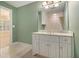 Bright vanity with a neutral countertop, lots of cabinet space, and tile flooring at 1418 Brighton Pl, Loganville, GA 30052