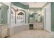 Spacious bathroom with garden tub, columns, dual sink vanity, and tile flooring at 1418 Brighton Pl, Loganville, GA 30052