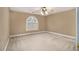 Bright bedroom with a ceiling fan and a large arched window with white blinds at 1418 Brighton Pl, Loganville, GA 30052