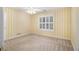 This bedroom boasts yellow striped wallpaper, a ceiling fan, and shuttered window at 1418 Brighton Pl, Loganville, GA 30052