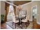 Formal dining room with a marble table, elegant chandelier, and large window for natural light at 1418 Brighton Pl, Loganville, GA 30052