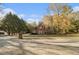 Well-maintained red brick home with mature trees and lawn on a sunny day at 1418 Brighton Pl, Loganville, GA 30052