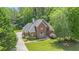 Beautiful brick home featuring a well-manicured lawn and mature trees, offering great curb appeal at 1418 Brighton Pl, Loganville, GA 30052