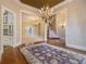 Elegant foyer showcasing hardwood floors, a crystal chandelier, and an open view of the living spaces at 1418 Brighton Pl, Loganville, GA 30052