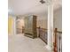 Hallway features an armoire, carpet, and wrought iron banister with a decorative column nearby at 1418 Brighton Pl, Loganville, GA 30052