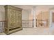 Hallway features an armoire, carpet, and wrought iron banister with a decorative column nearby at 1418 Brighton Pl, Loganville, GA 30052