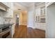 Kitchen with granite counters, white cabinetry, hardwood floors, and stainless steel appliances at 1418 Brighton Pl, Loganville, GA 30052
