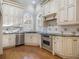 Kitchen features ornate white cabinetry, stainless steel appliances, and granite countertops at 1418 Brighton Pl, Loganville, GA 30052