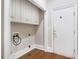 Bright laundry area features upper cabinets, base trim and hardwood flooring at 1418 Brighton Pl, Loganville, GA 30052