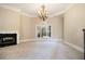Spacious living room with plush carpet, fireplace, and an elegant chandelier at 1418 Brighton Pl, Loganville, GA 30052
