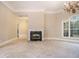 Spacious living room with a fireplace and a large arched window, perfect for entertaining at 1418 Brighton Pl, Loganville, GA 30052