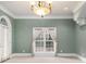 Large living room with a window and a chandelier at 1418 Brighton Pl, Loganville, GA 30052