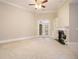 Well-lit living room with ceiling fan, fireplace, french doors, and built-in shelving at 1418 Brighton Pl, Loganville, GA 30052