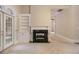 Light-filled living room with fireplace, built-ins, and french doors to the exterior at 1418 Brighton Pl, Loganville, GA 30052