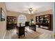 Well-lit office with ample shelving, desk, and a neutral color scheme, ideal for productivity at 1418 Brighton Pl, Loganville, GA 30052
