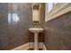 Cozy powder room features a pedestal sink, decorative wall covering and window with shutters at 1418 Brighton Pl, Loganville, GA 30052