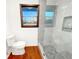 Renovated bathroom featuring stylish tiled shower, modern toilet, and natural light at 144 Morning Creek Rd, Jonesboro, GA 30238