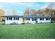 Charming ranch home featuring freshly painted white brick and a bright yellow front door at 144 Morning Creek Rd, Jonesboro, GA 30238