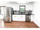 Bright kitchen with stainless steel appliances, subway tile backsplash, and hardwood floors at 144 Morning Creek Rd, Jonesboro, GA 30238