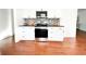 Modern kitchen featuring stainless steel appliances, black countertops, and updated cabinets at 144 Morning Creek Rd, Jonesboro, GA 30238