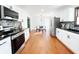 Open kitchen with stainless steel appliances, dark countertops, and dining area at 144 Morning Creek Rd, Jonesboro, GA 30238